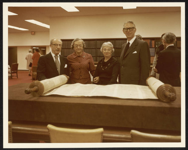 1960s_(L-R) Rabbi Levi Olan, Sarita Olan, Shirley Alweis, Norman Alweis. Standing behind the Czech Torah Scroll (BRMS60) at a Bridwell Library High Tea. Sunday, January 16, 1977.